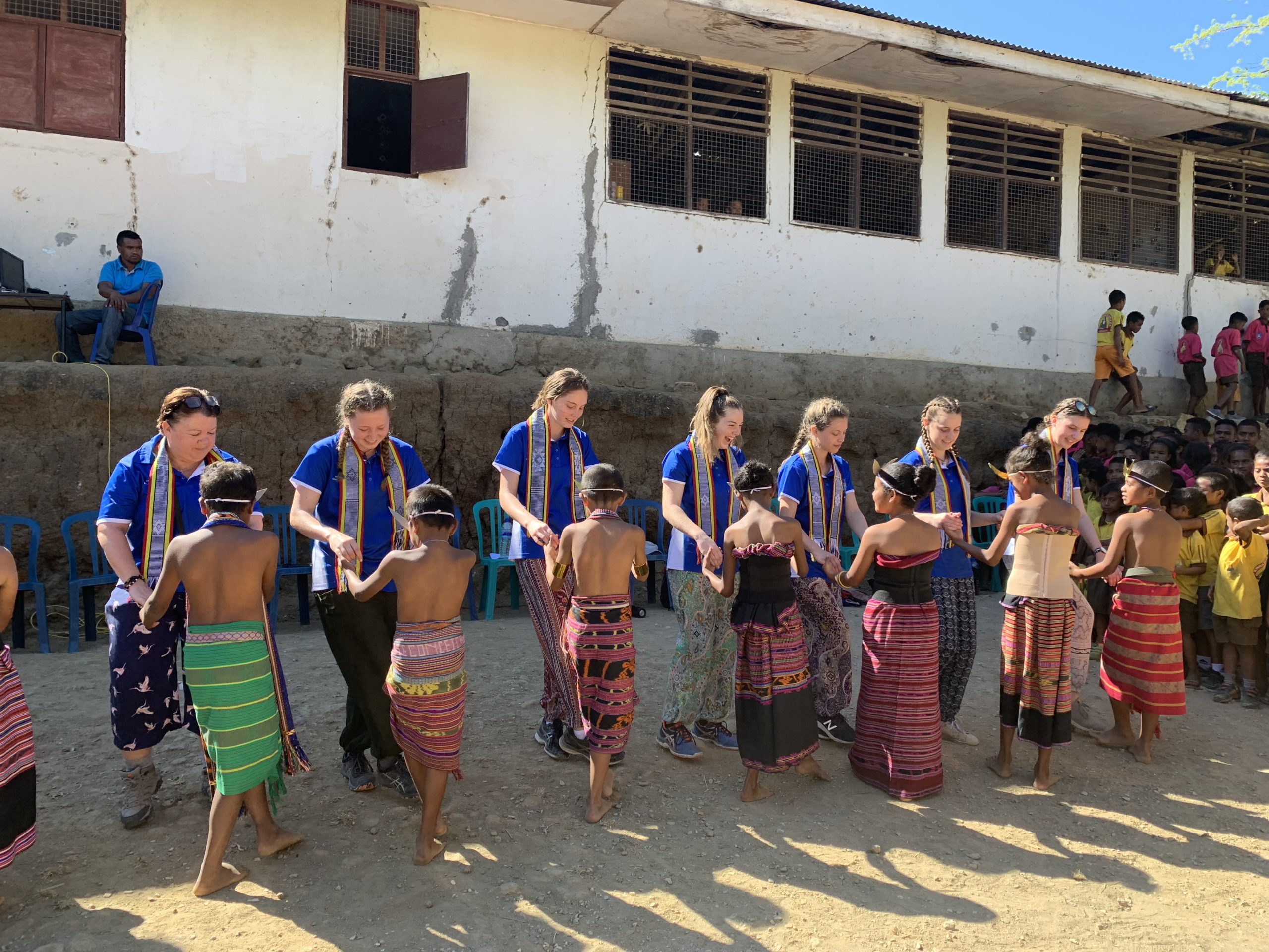 Immersion students from Assumption College Kilmore dancing with children in Timor-Leste